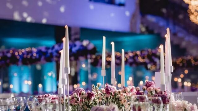 a table with flowers and candles