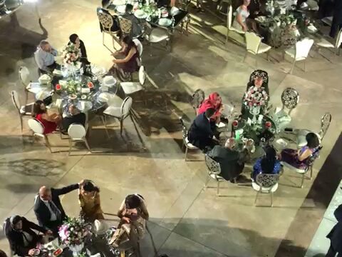 a group of people sitting around tables