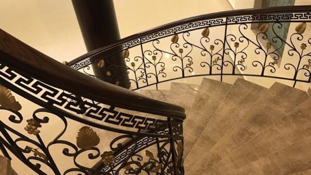 a spiral staircase with a metal railing