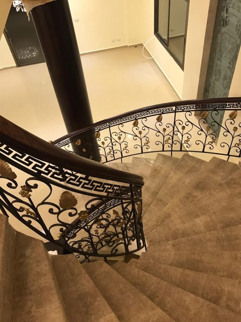 a spiral staircase with a metal railing