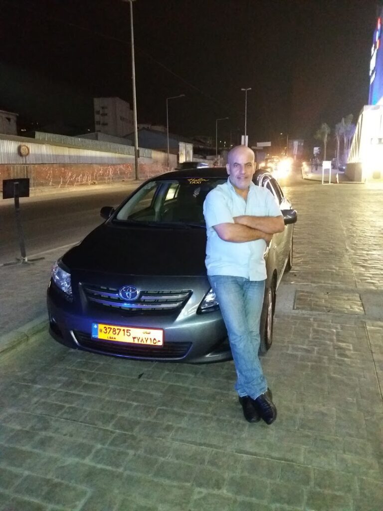 a man leaning on a car