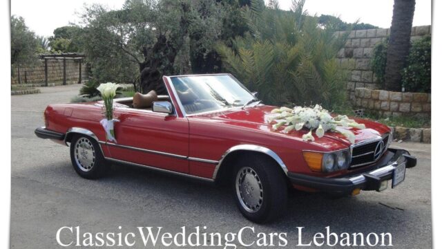 a red car with flowers on the hood