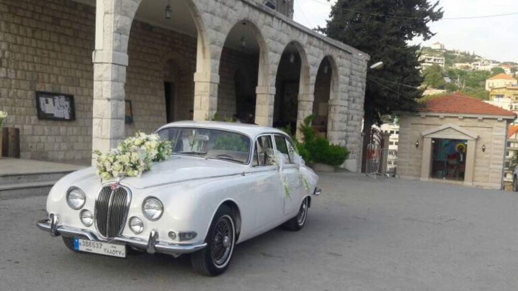 a white car with flowers on the hood