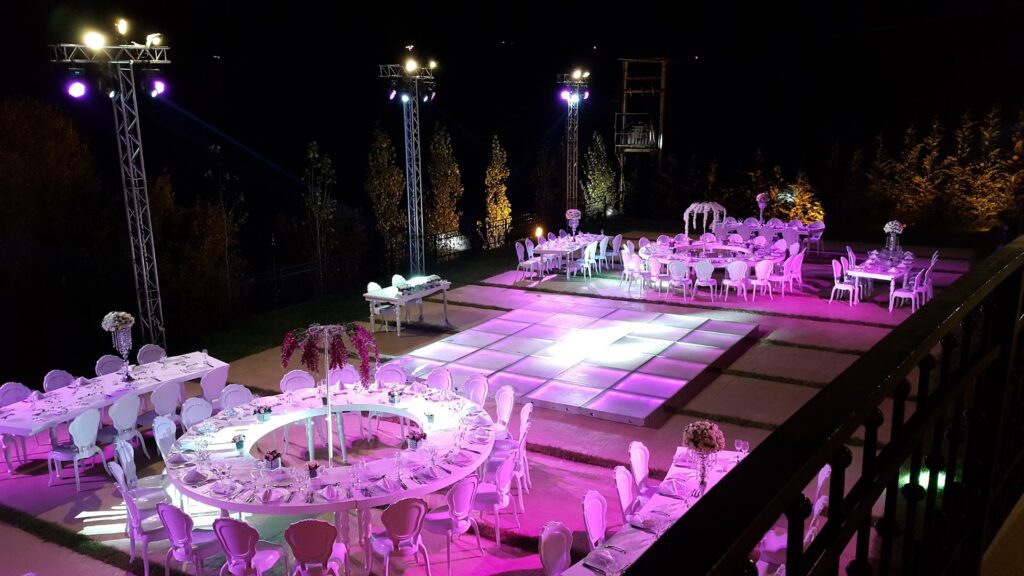 a outdoor event setting with tables and chairs
