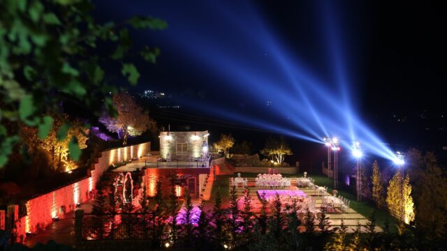 a lit up area with tables and chairs