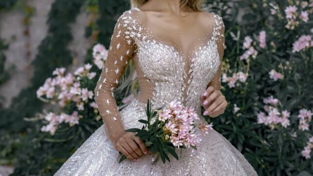 a woman in a dress holding flowers