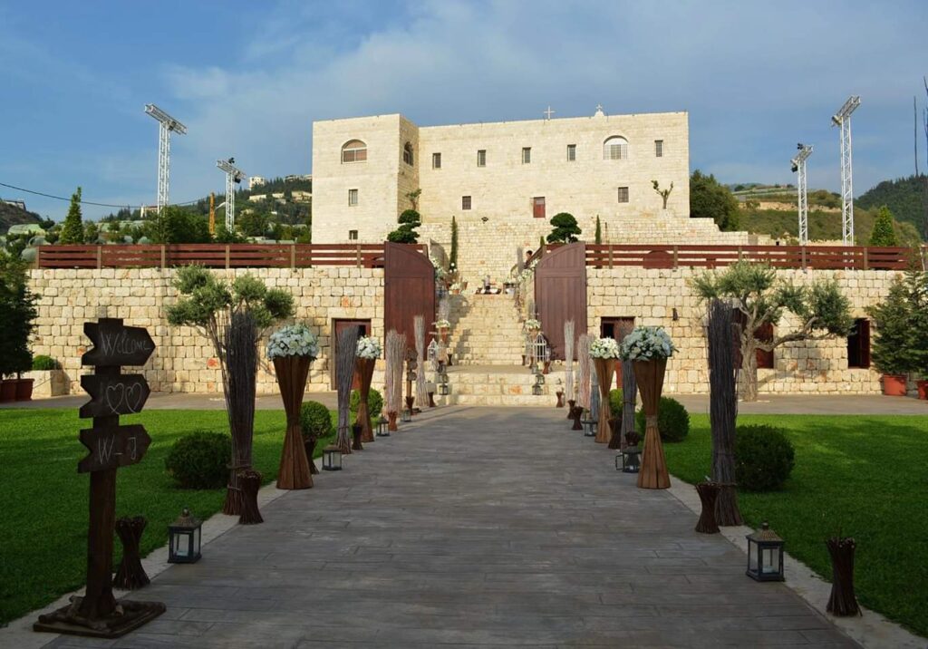 a stone building with a stone wall and a stone walkway