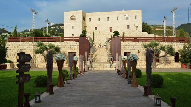 a stone building with a stone wall and a stone walkway