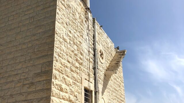 a stone building with a bell tower