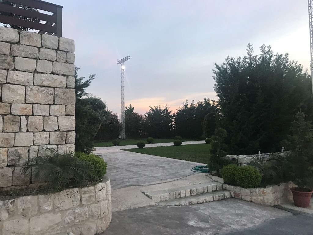 a stone wall with a stone wall and a stone wall with a light on the top