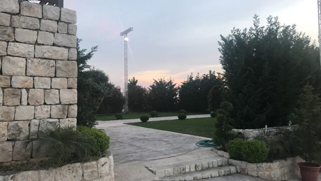 a stone wall with a stone wall and a stone wall with a light on the top