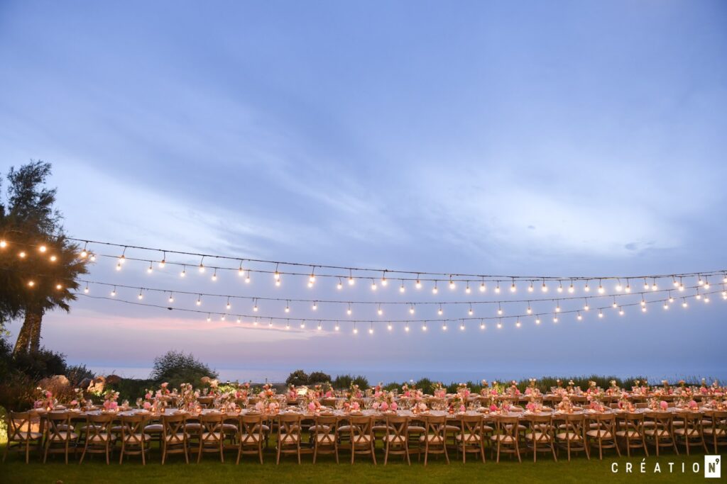 a long table set up with tables and lights