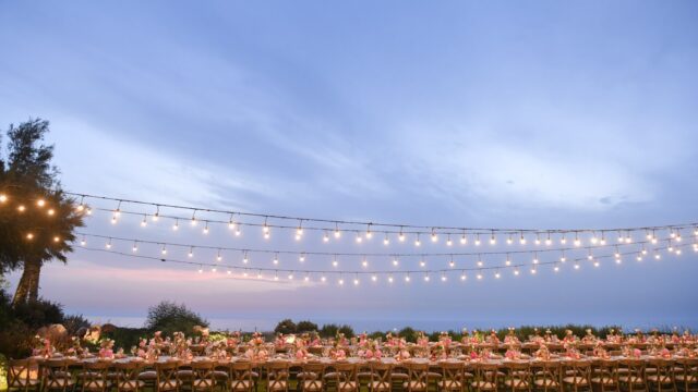 a long table set up with tables and lights