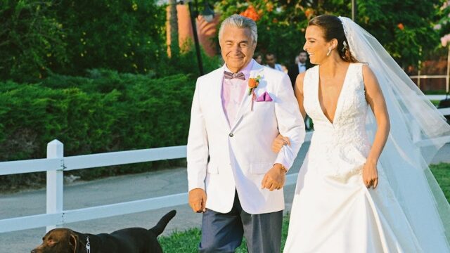 a man and woman walking a dog