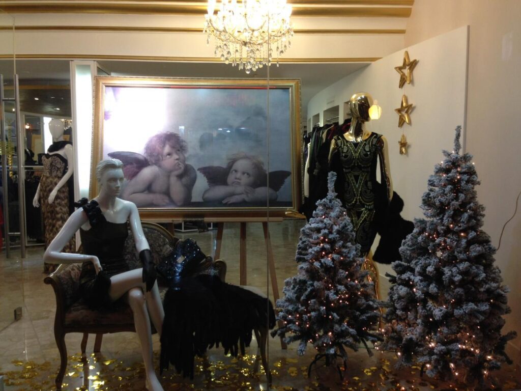 a mannequins in a room with christmas trees and a picture