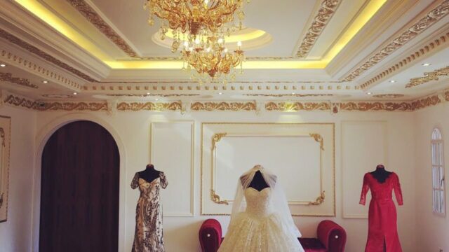 a room with a dress and a chandelier