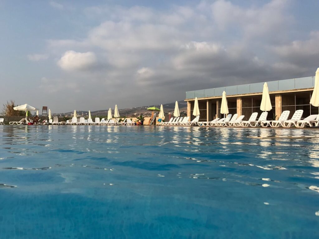 a pool with chairs and umbrellas