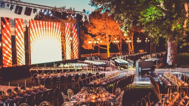 a outdoor event with tables and chairs