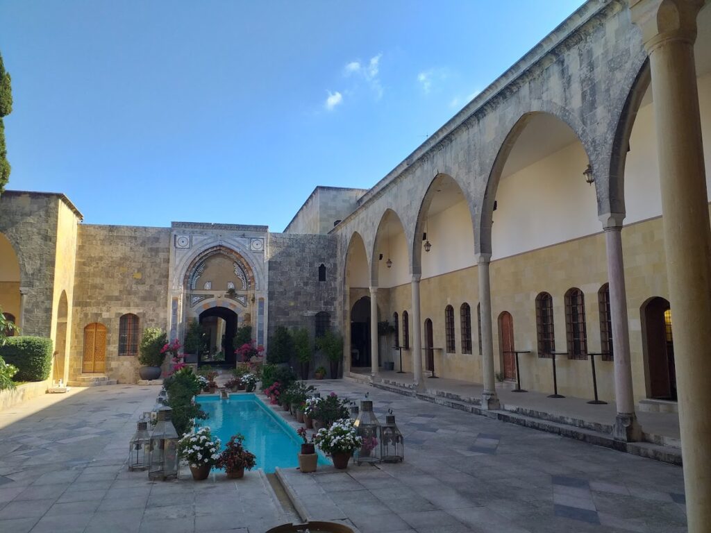 a courtyard with a pool and flowers