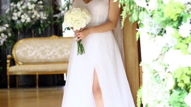 a woman in a white dress holding a bouquet