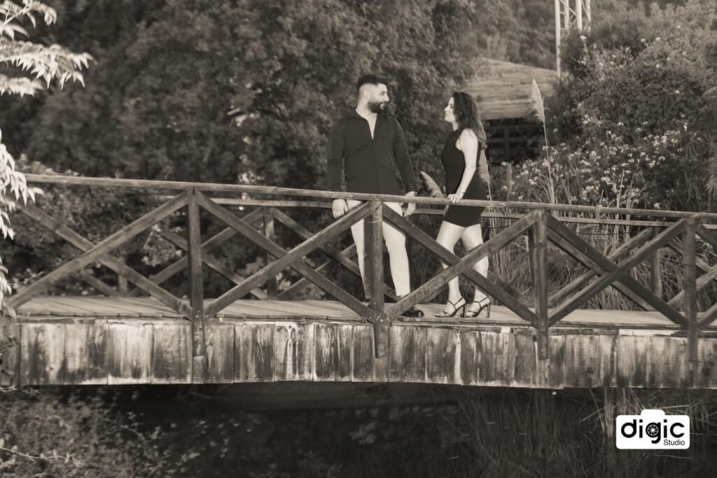 a man and woman standing on a bridge