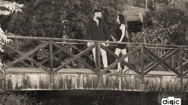 a man and woman standing on a bridge