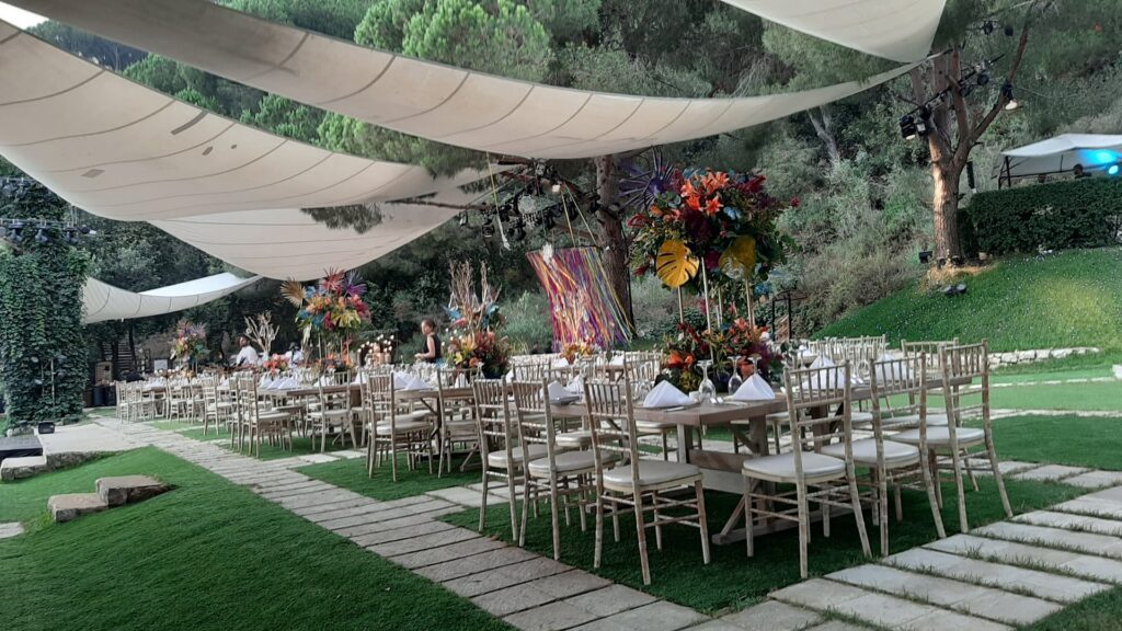 a group of tables and chairs under a canopy