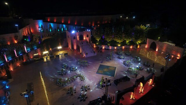 an outdoor event area with tables and chairs