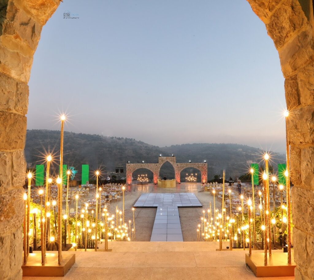 a stone arch with lights and a stage