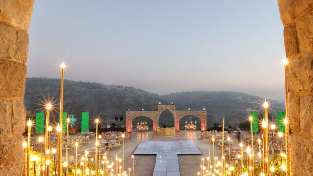 a stone arch with lights and a stage