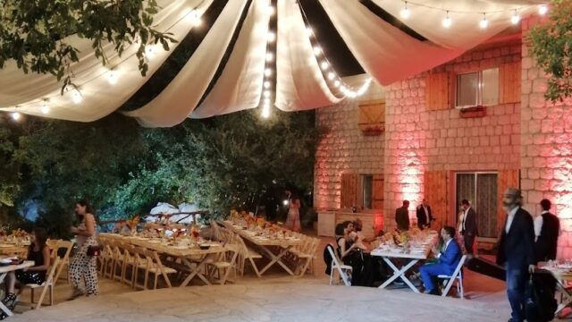 a group of people outside with a tent and tables and chairs