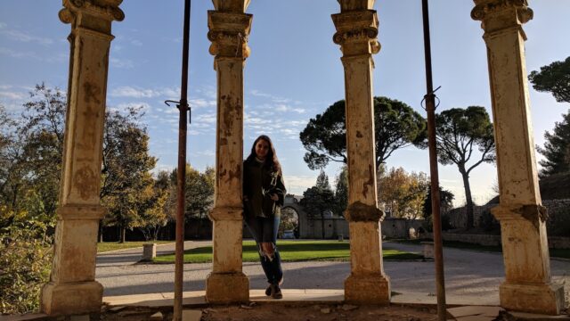 a woman standing in a stone archway