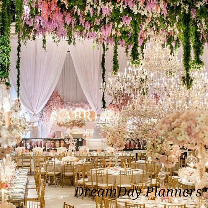 a wedding reception with chandeliers and flowers