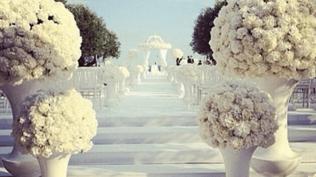 a white aisle with white flowers