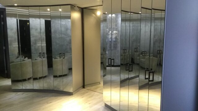 a room with mirrors and a white floor