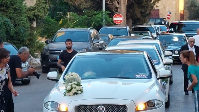 a white car with flowers on the hood