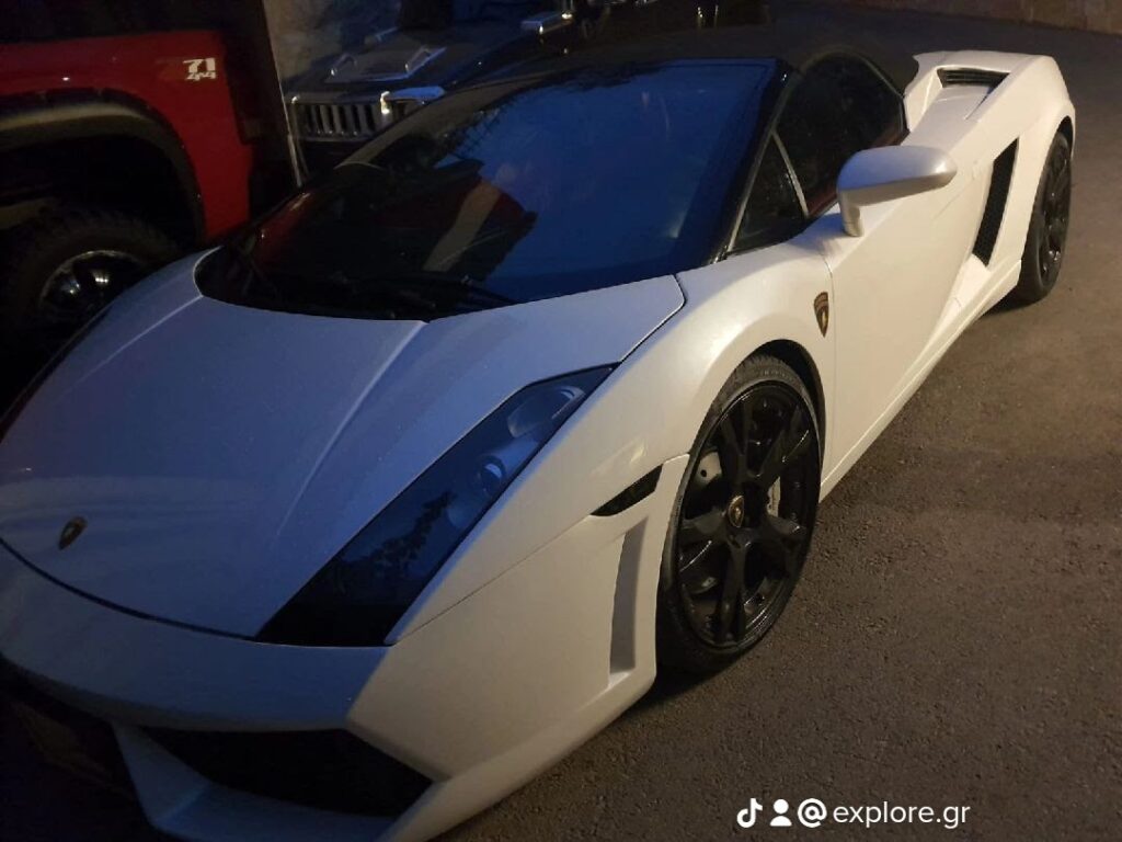 a white sports car parked in a parking lot