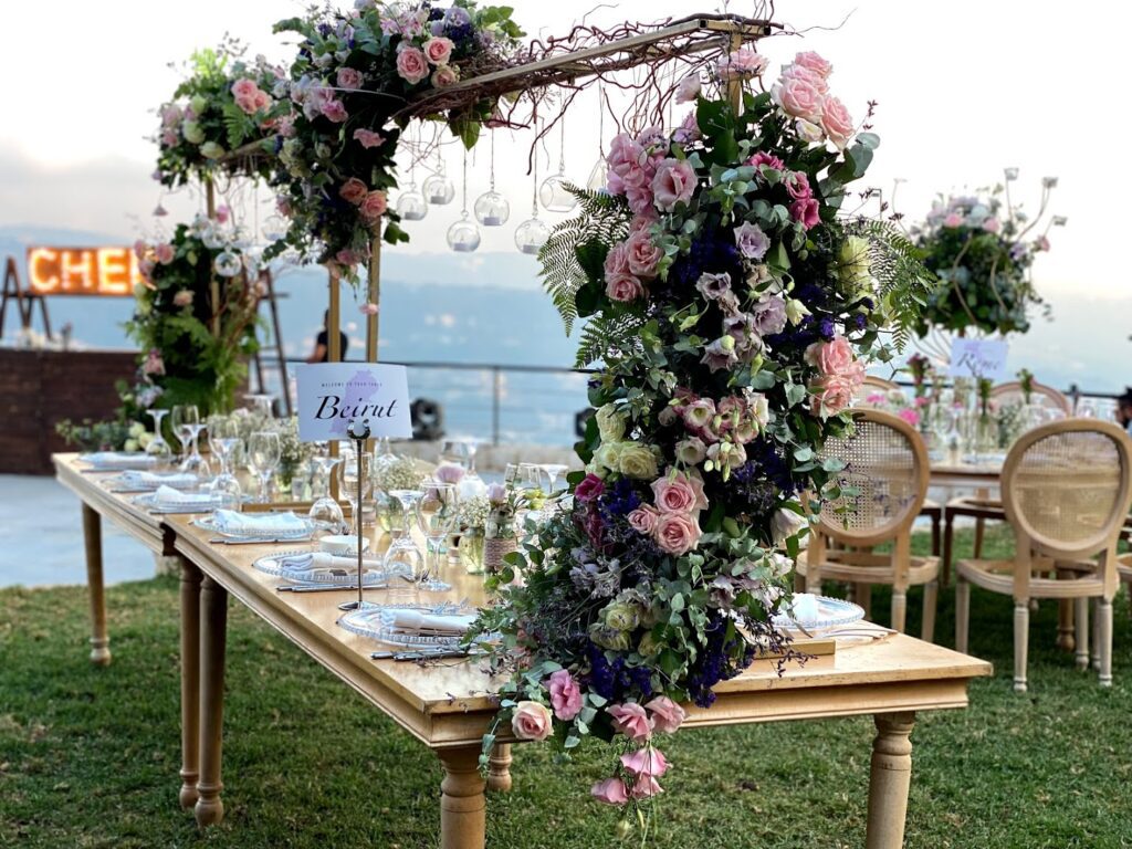 a table with flowers and plates on it