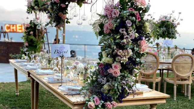 a table with flowers and plates on it