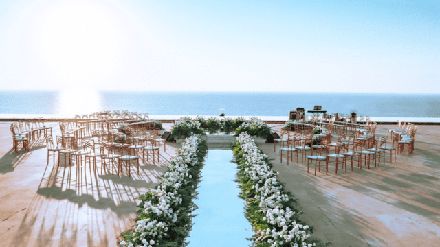 a wedding set up with chairs and tables and flowers