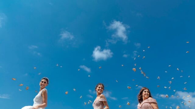 a group of women in dresses throwing butterflies