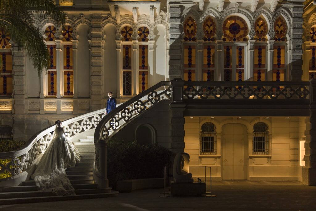 a man and woman standing on a staircase outside of a building