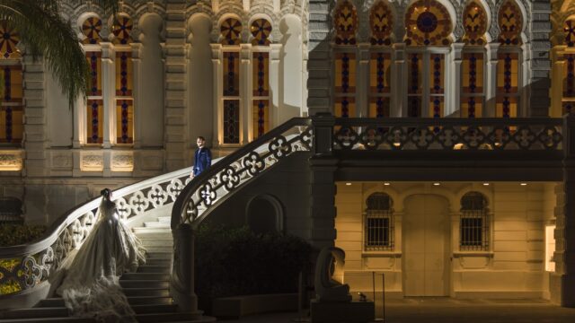 a man and woman standing on a staircase outside of a building