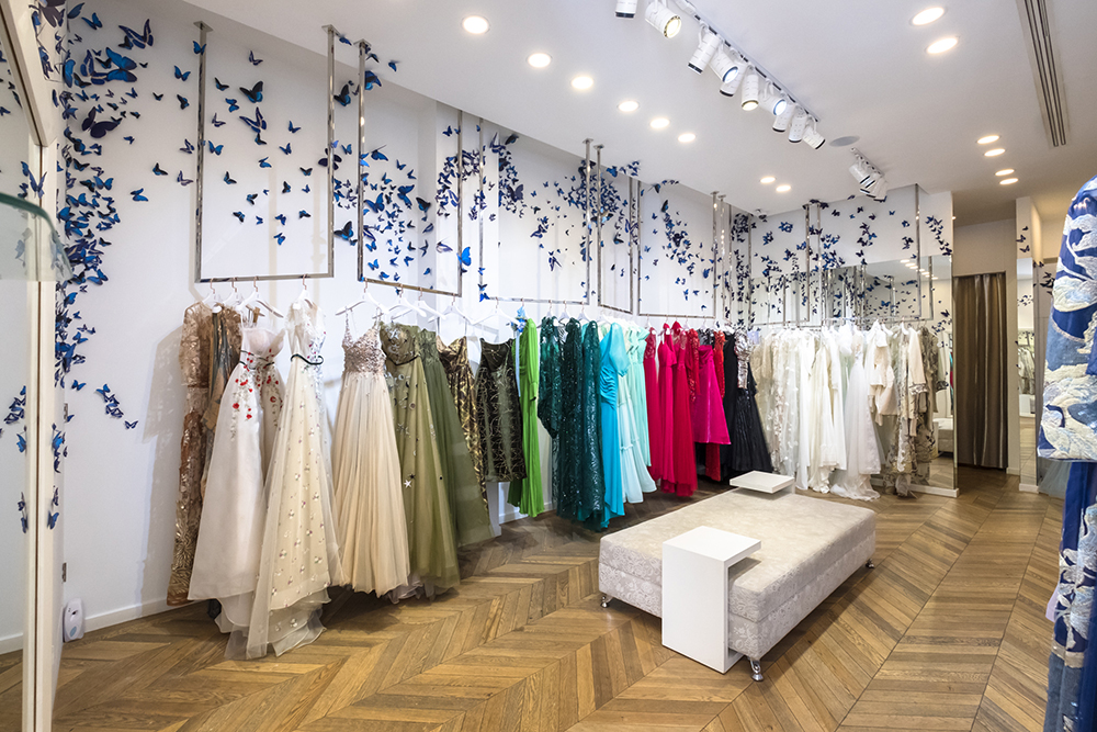 a room with dresses and butterflies on the wall