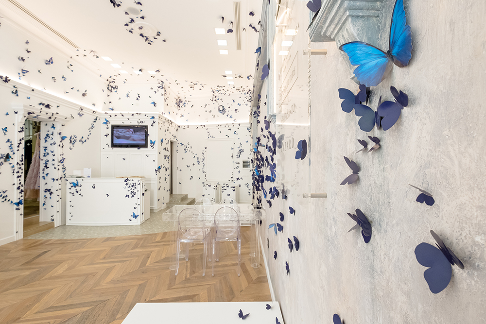 a room with blue butterflies on the wall