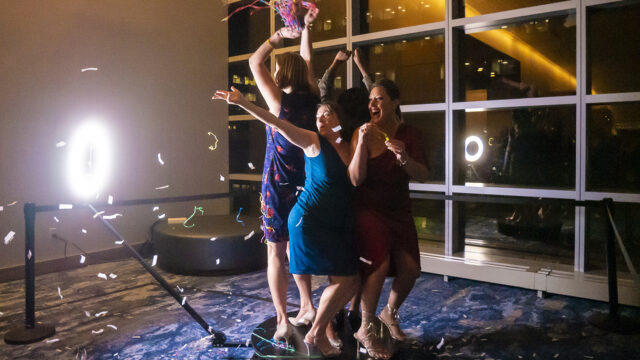 "Eventic LB: A group of women dancing in a room with confetti."