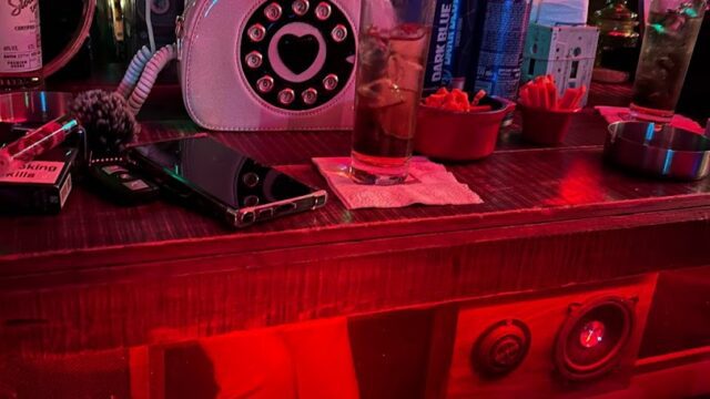 a bar with a phone and drinks