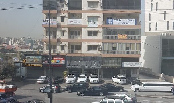 a building with cars parked in front of it