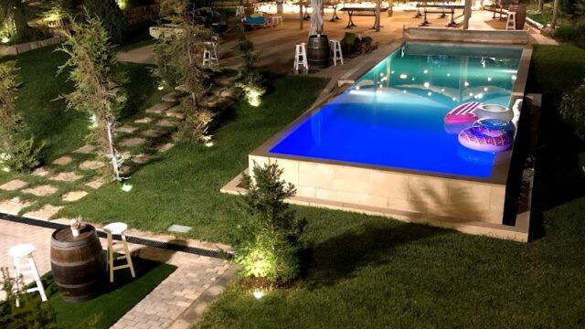 a pool with lights and trees