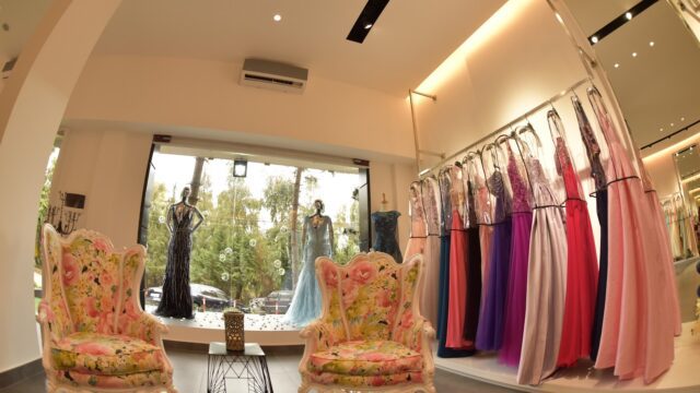 a room with a store with dresses on swingers